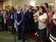 State Rep. Monica Stonier, D-Vancouver, second from right, applauds after Rep. Laurie Jinkins, in blue, was introduced at a news conference following a vote by Democrats choosing Jinkins as speaker of the House. Stonier was one of four female representatives seeking the top spot.