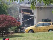 The remains of a Washougal home following an early Friday morning fire. Firefighters were still on scene spraying water on smoldering debris by late afternoon. The single occupant of the home was rescued by his neighbor, who pried open the garage door while the house was on fire.