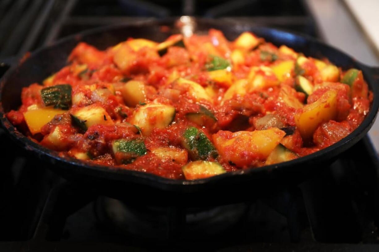 Ratatouille typically consists of roughly equal amounts of eggplant, zucchini and bell pepper, flavored with onion, garlic and herbs. Tomato is added in direct proportion to the cook’s tastes.