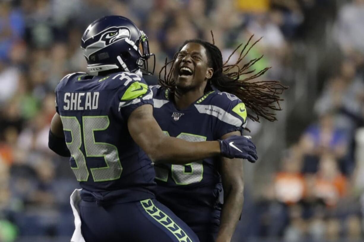 Seattle Seahawks’ DeShawn Shead (35) and Shaquem Griffin celebrate a play against the Denver Broncos during the second half of an NFL football preseason game, Thursday, Aug. 8, 2019, in Seattle.