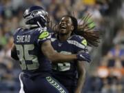 Seattle Seahawks’ DeShawn Shead (35) and Shaquem Griffin celebrate a play against the Denver Broncos during the second half of an NFL football preseason game, Thursday, Aug. 8, 2019, in Seattle.