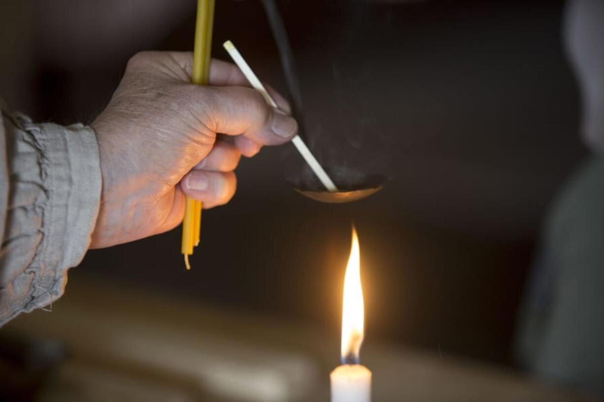 Park Guide Brett Roth demonstrate how to make a brimstone candle at Fort Vancouver Sunday May 26, 2018. The event, called “Survive and Thrive” is part of a free summer program in which members of the public can learn outdoor skills.