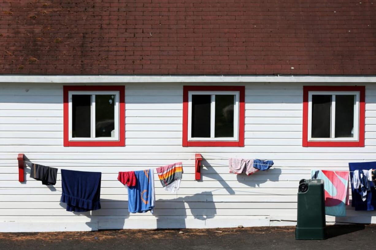 Towels and clothing hang to dry outside a cabin Aug. 15 during the weeklong Experience Camp at Camps Equinunk and Blue Ridge in Equinunk, Pa. The free program is for children who have lost a parent, sibling or caregiver and involves traditional summer camp experiences as well as clinical grief activities.