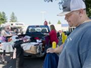 Vancouver resident Charles Hanset, at right, who marked two years of sobriety in June, volunteers by donating clothes and food to the homeless at the Vancouver Navigation Center, a homeless resource center.