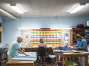 Sandy Hubbard, left, Shaune Kelly, and Julie Love are among the volunteers in the Helping Hands Sewing Group at St. Luke’s ~ San Lucas Episcopal Church in Vancouver. The group sews clothing for homeless children every Thursday.