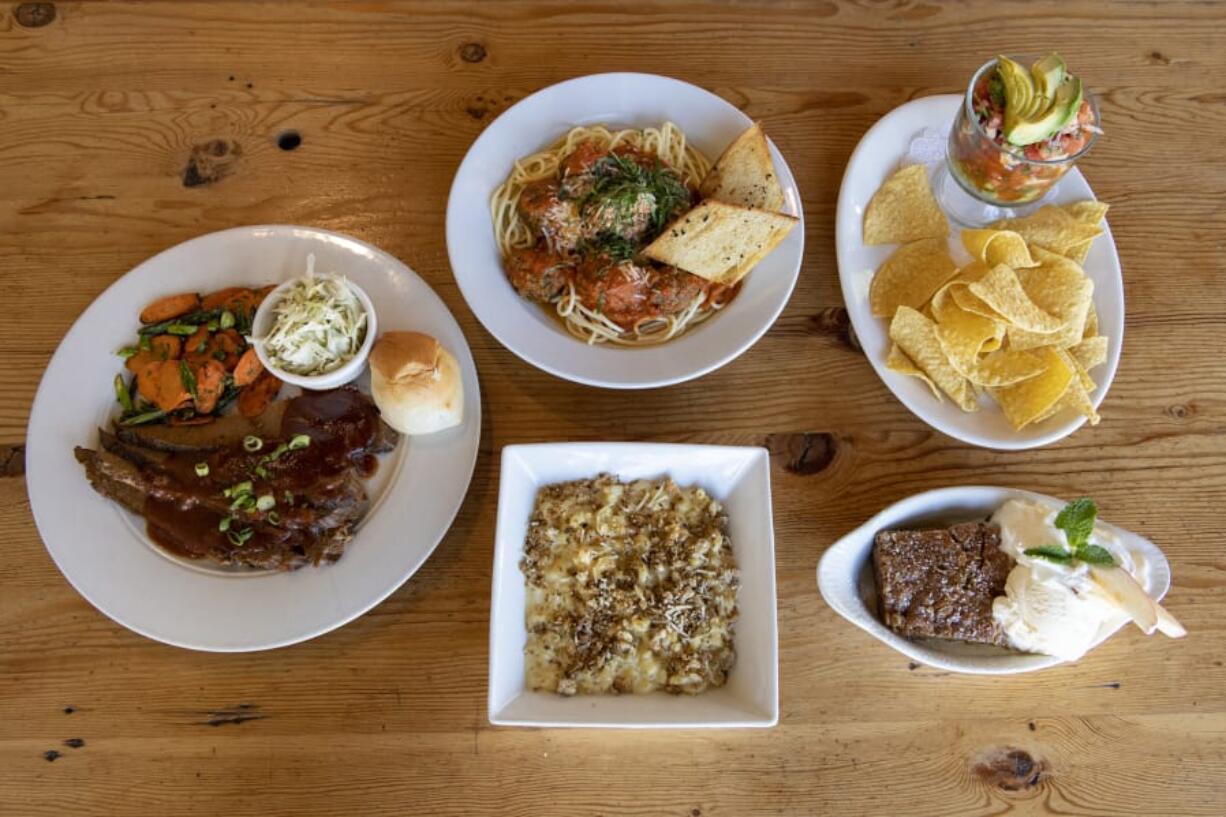 Brisket Platter, clockwise from left, spaghetti and meatballs, ceviche, apple crisp a la mode and Truffle Mac at Alex Smokehouse.