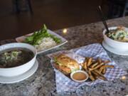 The Pho Tai Nam (eye round and flank noodle soup), from left, the Krispy Chicken Burger and the Vegetarian Noodle Soup at the Kooky Chicken.