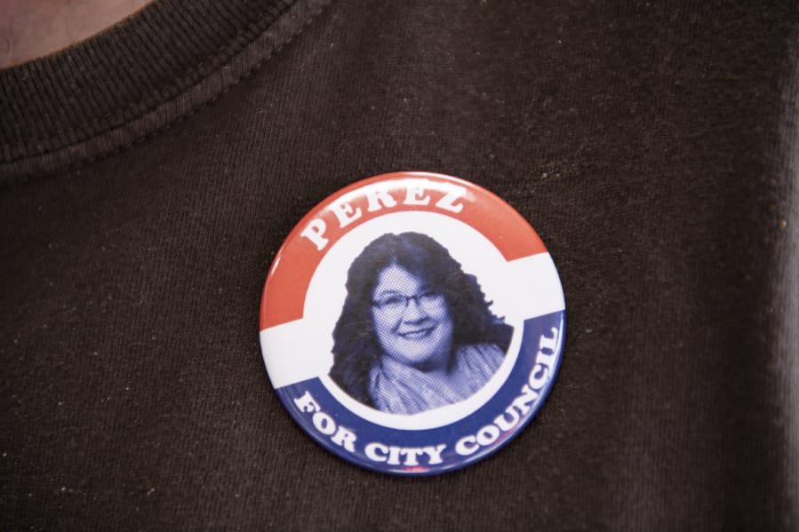 Dave Guduchieyano of Vancouver displays a button in support of Vancouver City Council candidate Diana Perez during a meet-and-greet hosted by two business owners on Tuesday.