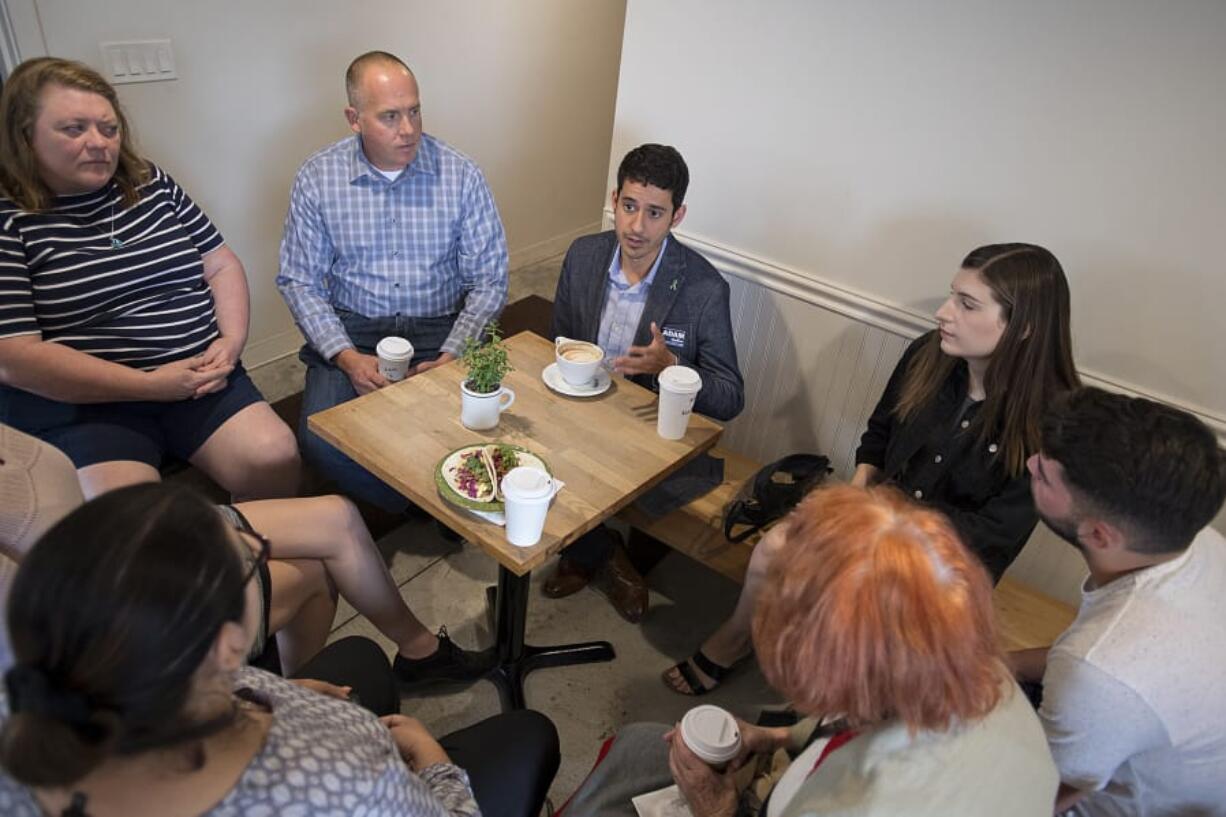 Adam Aguilera, center in gray jacket, chats with voters at River Maiden on Tuesday morning. Aguilera’s one of seven seeking the Position 6 seat on the Vancouver City Council.