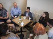 Adam Aguilera, center in gray jacket, chats with voters at River Maiden on Tuesday morning. Aguilera’s one of seven seeking the Position 6 seat on the Vancouver City Council.