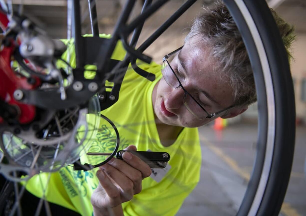 Bike Skills 101 Camp counselor Aidan Billingsley, 16, teaches participants how to repair bike brakes. He rides his bike to get to school and his summer job.