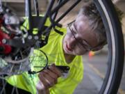 Bike Skills 101 Camp counselor Aidan Billingsley, 16, teaches participants how to repair bike brakes. He rides his bike to get to school and his summer job.