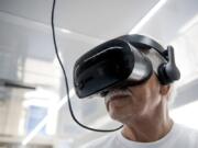 Faiz Humadi, 72, a retired civil engineer originally from Iraq, uses the virtual reality goggles inside the All of Us van in the parking lot of the Grocery Outlet Bargain Market on Fourth Plain Boulevard. The VR goggles teach people about the impact of certain medical breakthroughs.