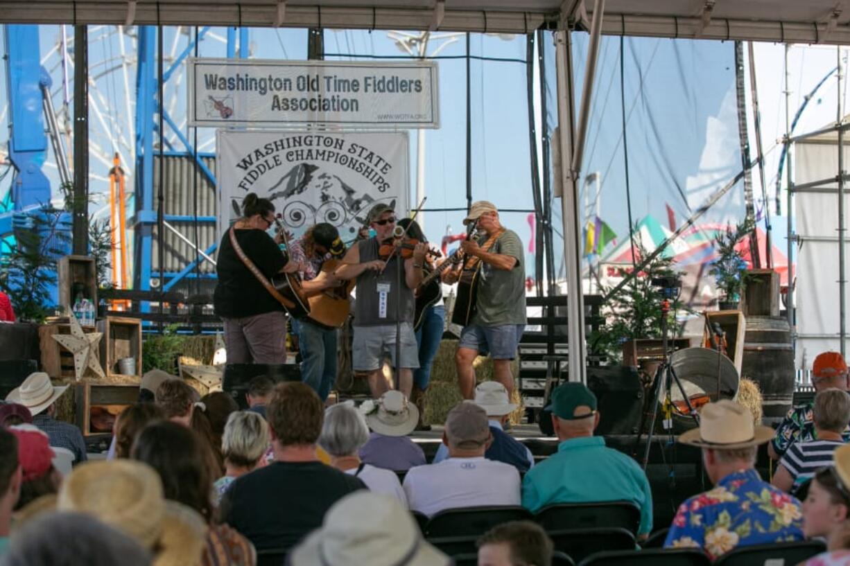 Tom Weisgerber takes the stage Sunday afternoon during Championship Round 3 of the Washington State Fiddle Championships at the Clark County Fair. Weisgerber took the top prize and the $1,000 reward that comes with it.