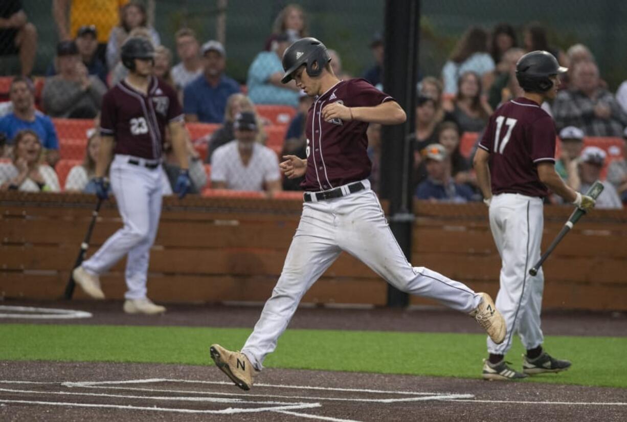 Ridgefield Raptors’ Cameron Repetti (6) scores on a passed ball against the Bend Elks at the Ridgefield Outdoor Recreation Complex on Friday evening. Repetti was the hero on Saturday with a three-run game-winning home run in the 11th inning.