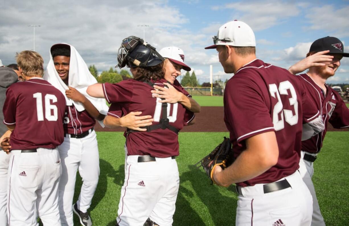 Members of the Ridgefield Raptors hug each other after defeating the Bend Elks in the final game of the West Coast League season Sunday at the Ridgefield Outdoor Recreation Complex. In their inaugural season, the Raptors averaged about 1,200 fans a game.