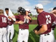 Members of the Ridgefield Raptors hug each other after defeating the Bend Elks in the final game of the West Coast League season Sunday at the Ridgefield Outdoor Recreation Complex. In their inaugural season, the Raptors averaged about 1,200 fans a game.