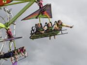 Amelia Canterbury, 9, of Vancouver, left, flies on the Cliff Hanger.