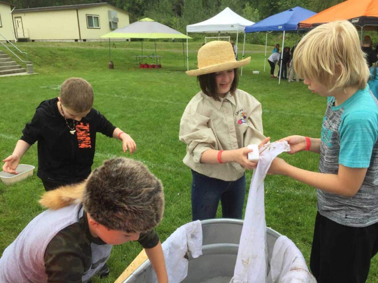 RIDGEFIELD: On Pioneer Day, fourth-grade students at South Ridge Elementary School learned to wash clothes the old-fashioned way: with bars of soap, washboards and tubs of water. Following several weeks of learning about pioneers, students had the opportunity to dress up and simulate the real activities of pioneers.