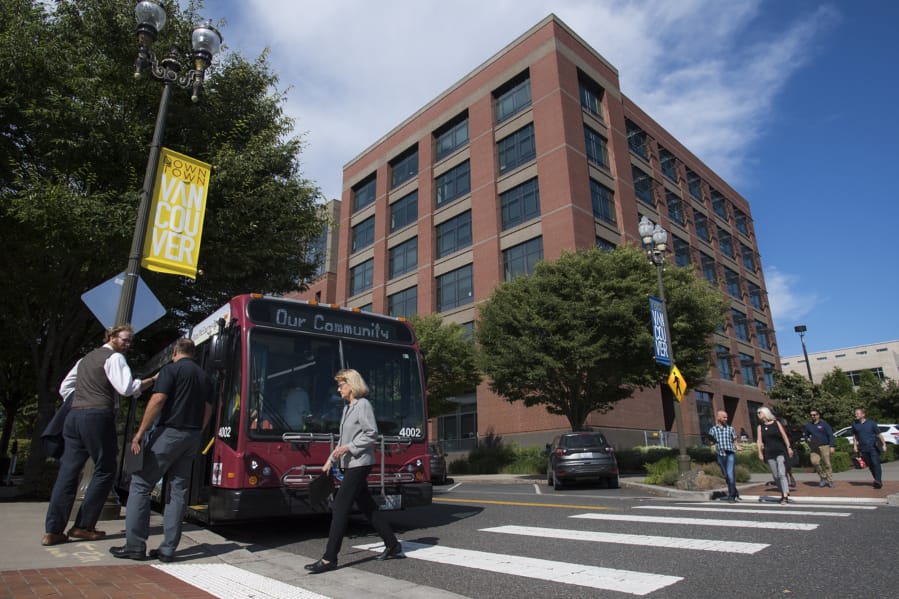 Attendees of the Vancouver City Council mobile workshop load onto a C-Tran bus at the beginning of the tour on Monday evening, Aug. 12, 2019.