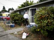 Vancouver Deputy Fire Marshal Skip Navarrette goes door to door to hand out fire prevention education materials as a part of Project Home Safe in Vancouver on Aug. 10.