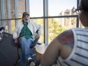 Jack Crowley of Battle Ground speaks with Community Services Northwest case manager Jamie Spinelli at the Vancouver Community Library. Spinelli recently helped Crowley find an apartment after he had been homeless for many years.