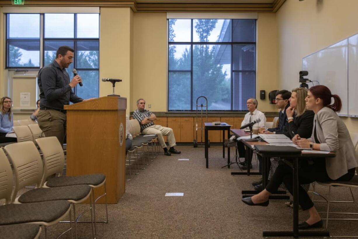 SEIU Local 775 member Ethan Shett, left, addresses Department of Labor and Industries representatives Allison Drake, from right, Elizabeth Smith and Joshua Grice during a public hearing Thursday morning regarding proposed changes to the state’s overtime rules.