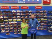 Orchards: Rosann Grzesiowski with the Orchards Evergreen Lions accepts a donation of new shoes from Billy Breece, manager of Big 5 Sporting Goods. The Lions are holding a shoe drive this month for kids at Fircrest Elementary School.