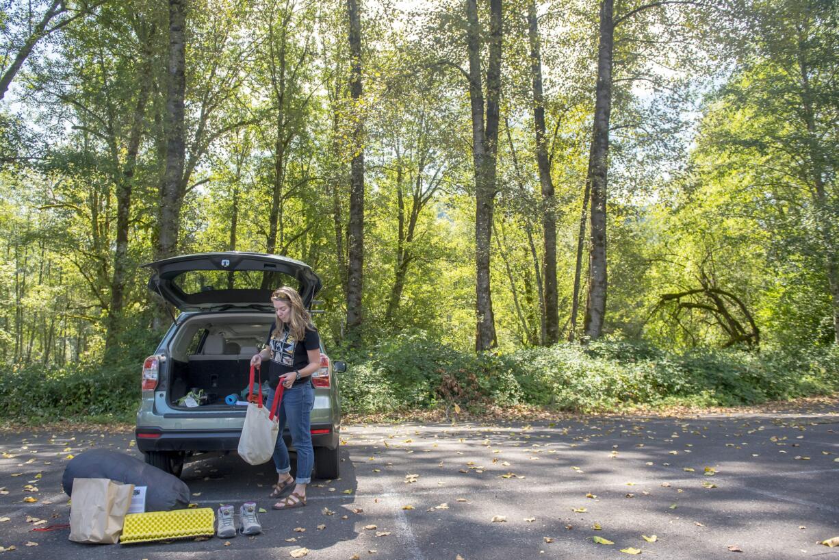 Sarah Croston, assistant guide and educator at the Mount St. Helens Institute takes stock of her equipment while preparing to lead a hike to the Mount. St. Helens crater.