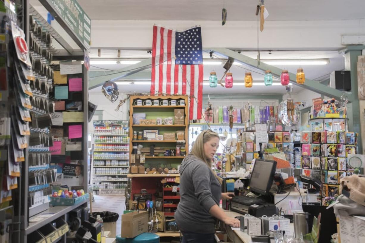 Erin Weichman, an employee at Ridgefield Hardware, records inventory on a computer while working on Friday morning. The store saw an uptick in customers this summer with “Main Street Moola” handed out at Ridgefield Raptors games.