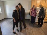 Christina LaCelle, a future Caples Terrace resident, from left, gets a hug from U.S. Sen. Maria Cantwell as they tour the new 28-unit apartment building with Dena Horton, Cantwell’s Southwest Washington outreach director, and Vancouver Mayor Anne McEnerny-Ogle on Monday morning. LaCelle said she was looking forward to enjoying her future home with her baby daughter.