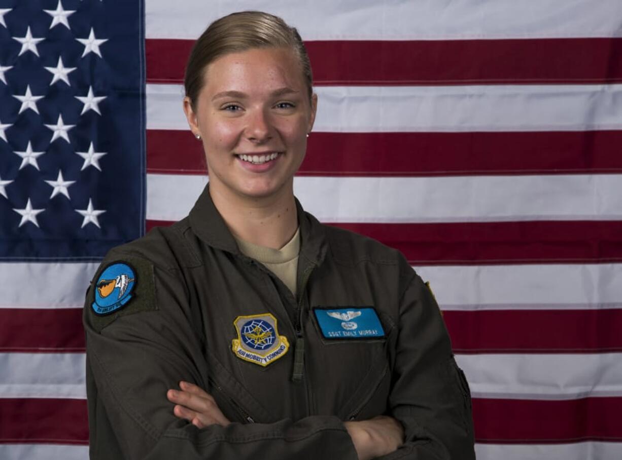 Staff Sgt. Emily O’Neil, 9th Airlift Squadron flight engineer and 2012 Hudson’s Bay High School graduate, stands by the U.S. flag at Dover Air Force Base, Del. Senior Airman Christopher Quail/U.S.