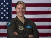 Staff Sgt. Emily O’Neil, 9th Airlift Squadron flight engineer and 2012 Hudson’s Bay High School graduate, stands by the U.S. flag at Dover Air Force Base, Del. Senior Airman Christopher Quail/U.S.