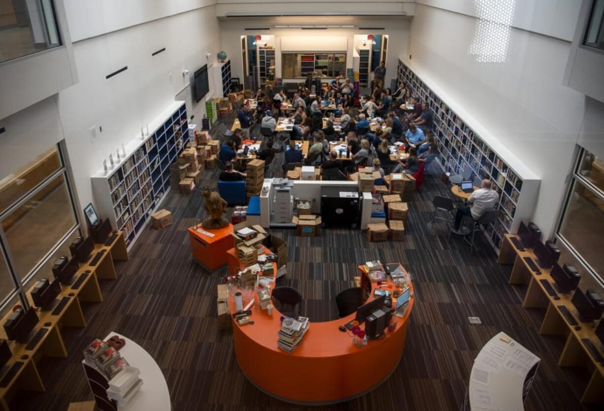 Ridgefield High School teachers meet in the media library in the new high school building, which will open in time for the start of the upcoming school year. The new building increases the size of the library and updates science labs, the Life Skills program and a few art classrooms.