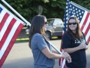 Rhiannon Parks, left, of Battle Ground and Michelle Dawson of Yacolt take part in a rally outside Yacolt Town Hall before Monday’s council meeting. Dawson and supporters had issues with how a recent decision was made to appoint a new town councilor.