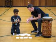 Fourth-grader Nash Bigelow claps along with camp volunteer Collin Stegner during a rhythm game at the two-week summer enrichment camp at Hough Elementary School in Vancouver on August 21, 2019. The free camp hosted by the Hough Foundation covered topics such as horticulture, Escola de Samba and beginning band.