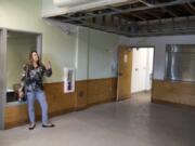 Amy Reynolds, deputy director of Share, stands in the dining room of Share House, which was damaged by fire last month. The dining room and kitchen had just been remodeled last summer.