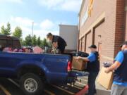 BENNINGTON: Volunteers load backpacks full of school supplies at the 430 S.E. 192nd Ave. Walmart Supercenter. Two-hundred kits were put together for approximately 100 military families in Clark County with a parent deployed or scheduled for deployment.