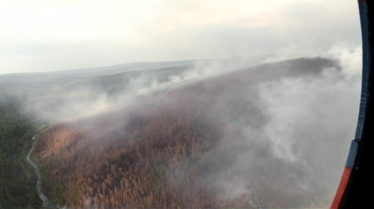 This image made from video provided by RU-RTR Russian television channel shows a view of a forest fire in the Boguchansky district of the Krasnoyarsk region, Russia Far East, Wednesday, July 31, 2019. Russian President Vladimir Putin has ordered Russia's military to join efforts to fight forest fires that have engulfed nearly 30,000 square kilometers (11,580 sq. miles) of territory in Siberia and the Russian Far East.