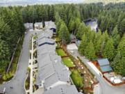 In this photo taken July 24, 2019, a block of houses are carved into a forest along the Middle Fork Snoqualmie River in the Cascade foothills of North Bend, Wash. Experts say global warming is changing the region’s seasons, bringing higher temperatures, lower humidity and longer stretches of drought. And that means wildfire risks in coming years will extend into areas that haven’t experienced major burns in residents’ lifetimes.