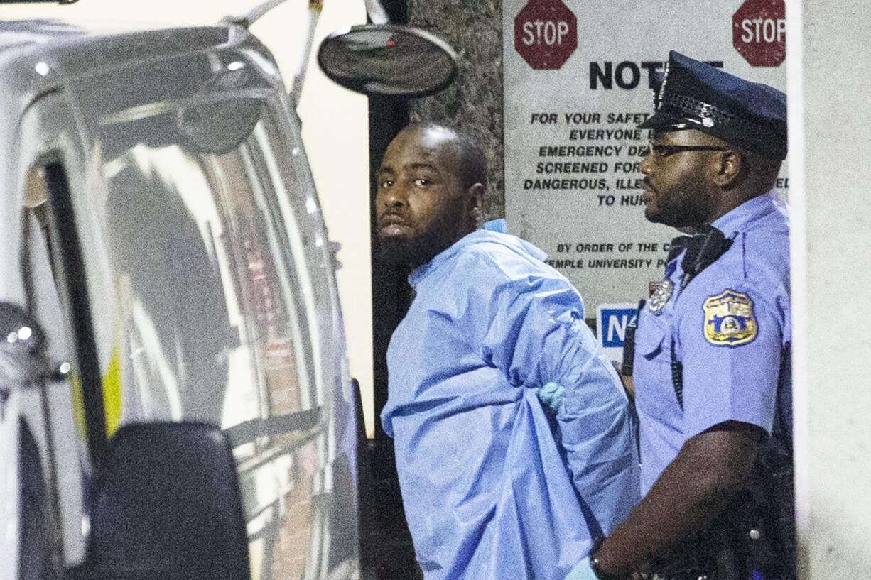 Police take shooting suspect, Maurice Hill, into custody after an hourslong standoff with police, that wounded several police officers, in Philadelphia early Thursday, Aug. 15, 2019.  The standoff started Wednesday afternoon, as officers went to a home to serve a narcotics warrant in an operation "that went awry almost immediately," Philadelphia Police Commissioner Richard Ross said.