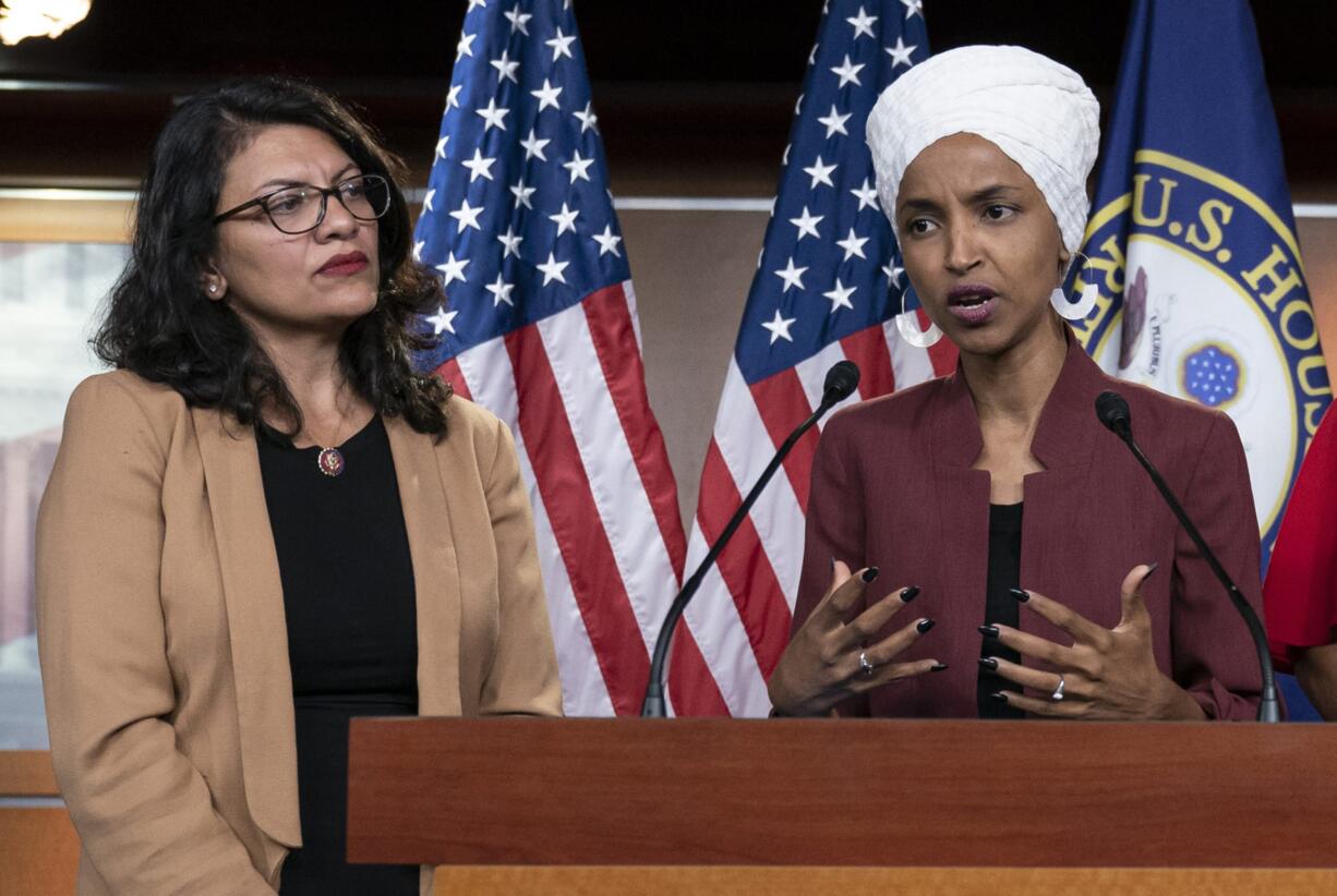 FILE - In this July 15, 2019, file photo, U.S. Rep. Ilhan Omar, D-Minn, right, speaks, as U.S. Rep. Rashida Tlaib, D-Mich. listens, during a news conference at the Capitol in Washington. The U.S. envoy to Israel said he supports Israel's decision to deny entry to two Muslim congresswomen ahead of their planned visit to Jerusalem and the West Bank. Ambassador David Friedman said Thursday, Aug. 15, 2019, in a statement following the Israeli government's announcement that Israel "has every right to protect its borders" against promoters of boycotts "in the same manner as it would bar entrants with more conventional weapons." (AP Photo/J.