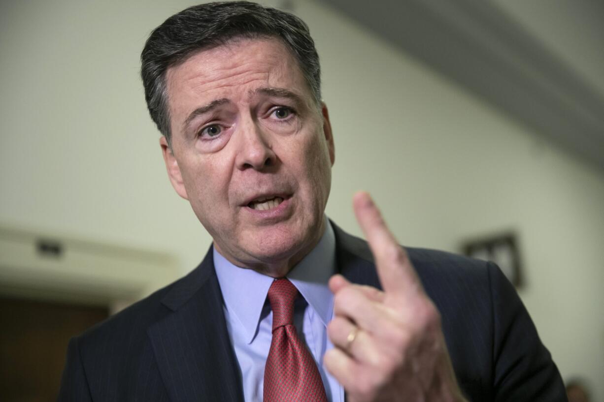 Former FBI Director James Comey speaks to reporters on Capitol Hill Washington. The Justice Department’s inspector general says former FBI Director James Comey violated FBI policies in his handling of memos documenting private conversations with President Donald Trump.  (AP Photo/J.