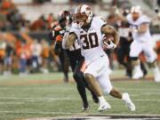 Oklahoma State wide receiver Chuba Hubbard (30) sprints up the field during the second half of an NCAA college football game with Oregon State in Corvallis, Ore., Friday, Aug. 30, 2019. Oklahoma State won 52-36.