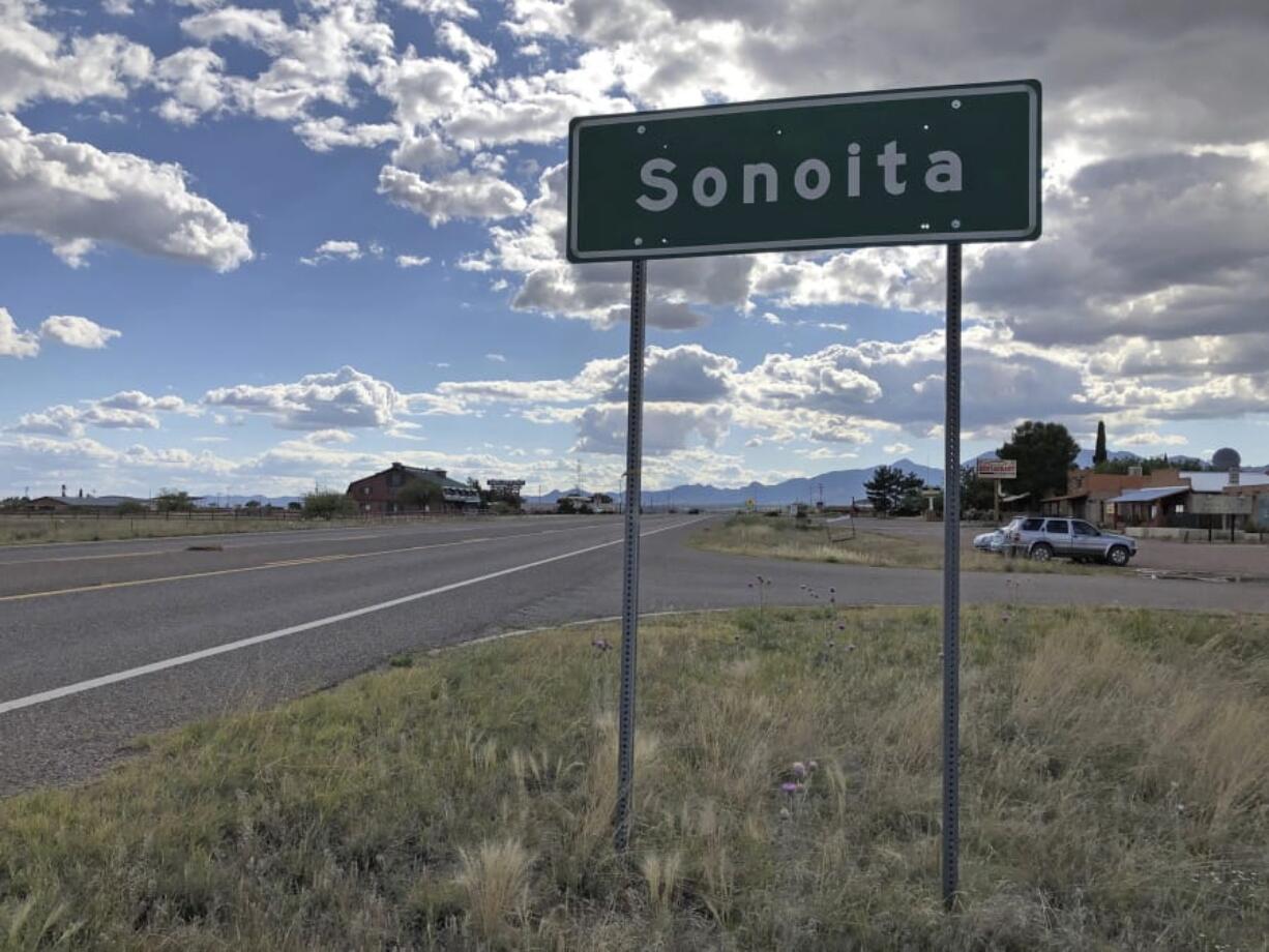 FILE - In this May 13, 2019, file photo, a sign for Sonoita stands in the heart of southeastern Arizona where owners of wineries and other small tourism operations worry that the Rosemont Copper Mine proposed to be built in the nearby Santa Rita Mountains could harm their businesses with mining trucks rumbling down scenic state highway 83 that runs past the range. A federal judge on Wednesday, July 31, 2019, has overturned the U.S. Forest Service’s approval of a Canadian company’s planned new copper mine in southeastern Arizona. The judge ruled the agency improperly evaluated and considered water use issues associated with the Rosemont Mine planned in the Santa Rita Mountains on part of the Coronado National Forest.