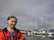 Greta Thunberg poses for a picture in the Marina where the boat Malizia is moored in Plymouth, England Tuesday, Aug. 13, 2019. Greta Thunberg, the 16-year-old climate change activist who has inspired student protests around the world, is heading to the United States this week - in a sailboat.