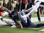 Seattle Seahawks quarterback Paxton Lynch scores a touchdown against the Denver Broncos during the second half of an NFL football preseason game Thursday, Aug. 8, 2019, in Seattle.