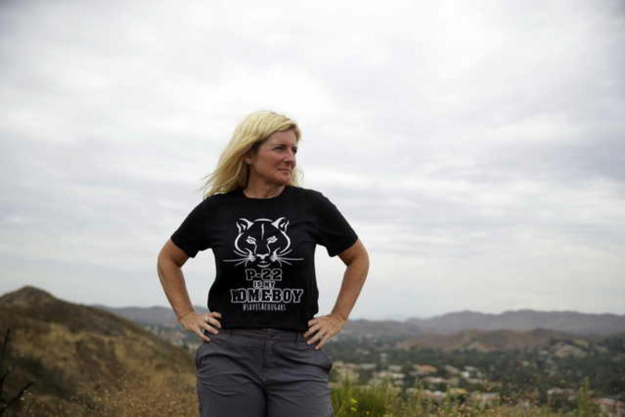 In this July 25, 2019, photo, Beth Pratt, California director for the National Wildlife Federation, stands on a hilltop overlooking U.S. Highway 101, near the site of a proposed wildlife crossing in Agoura Hills, Calif. Pratt is advocating for a wildlife crossing to go over the 101 freeway and connecting open space preserves, hoping for wildlife to have wider roaming spaces. The project is on track for groundbreaking within two years and completion by 2023.