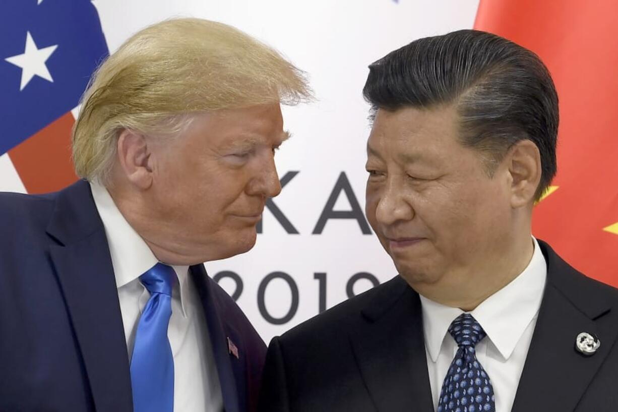 FILE - In this June 29, 2019, file photo, President Donald Trump, left, meets with Chinese President Xi Jinping during a meeting on the sidelines of the G-20 summit in Osaka, Japan. China has announced it will raise tariffs on $75 billion of U.S. products in retaliation for President Donald Trump’s planned Sept. 1 duty increase in a war over trade and technology policy.