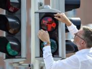 Director of Moesgaard Museum Mads Kähler Holst replaces the first of many pedestrian signals for Viking signals in Aarhus, Denmark, Monday, Aug. 26, 2019. The red and green Viking inspired signs have been chosen to symbolise Aarhus’s special Viking history.